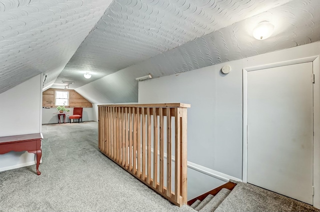 additional living space featuring vaulted ceiling, a textured ceiling, and carpet floors