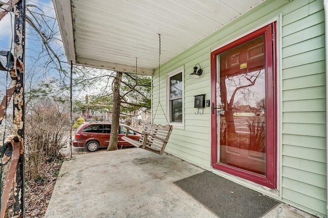 view of exterior entry featuring a porch