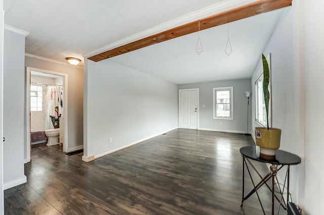 living room featuring dark wood-style floors, baseboards, and ornamental molding