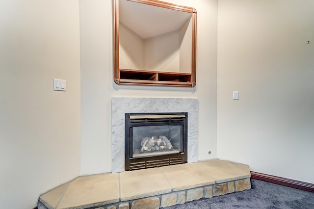 interior details with a premium fireplace and carpet flooring