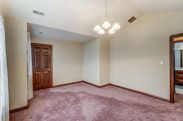 empty room with light colored carpet, lofted ceiling, and a notable chandelier