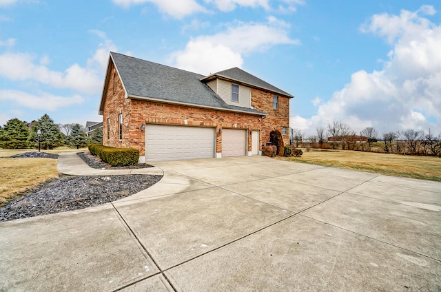 view of home's exterior with a garage and a yard