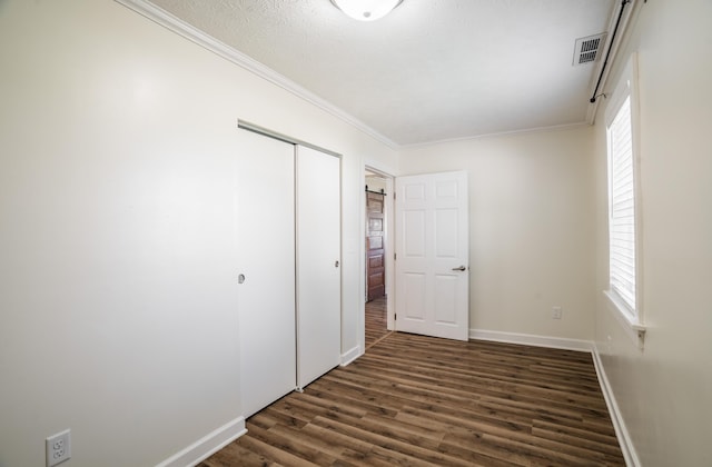 4209 State Route 41, Troy, OH 45373 - unfurnished bedroom featuring dark wood-style floors, a closet, baseboards, crown molding, and multiple windows