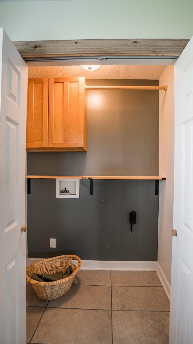 4209 State Route 41, Troy, OH 45373 - laundry room featuring washer hookup, cabinet space, tile patterned floors, and baseboards