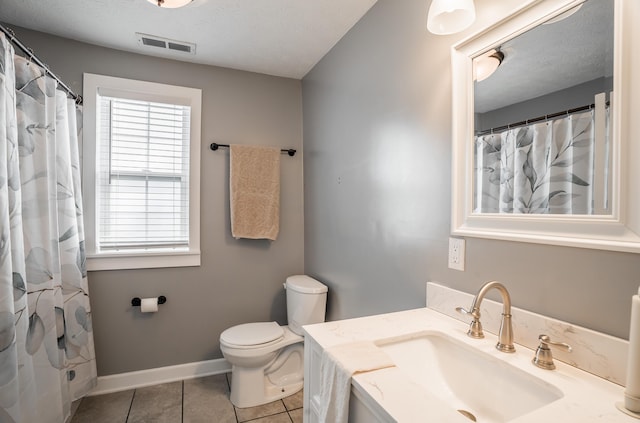 4209 State Route 41, Troy, OH 45373 - full bath featuring toilet, tile patterned flooring, vanity, baseboards, and a textured ceiling
