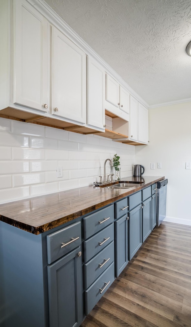 4209 State Route 41, Troy, OH 45373 - kitchen with butcher block countertops, a sink, stainless steel dishwasher, a textured ceiling, and white cabinetry