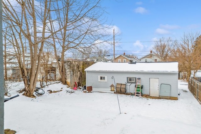 snow covered property featuring fence