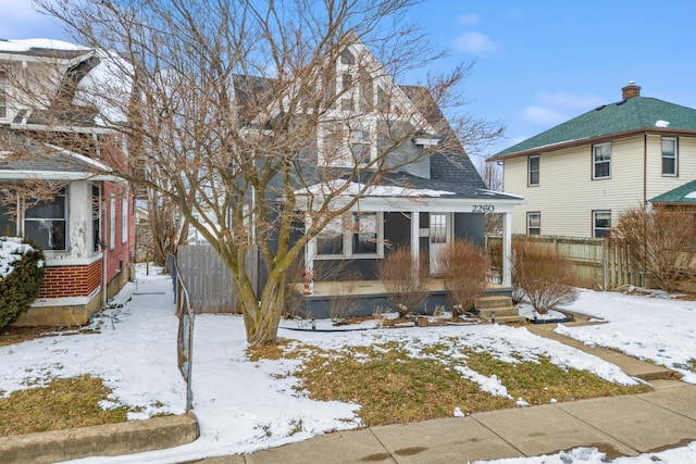 view of front of property with fence and a porch