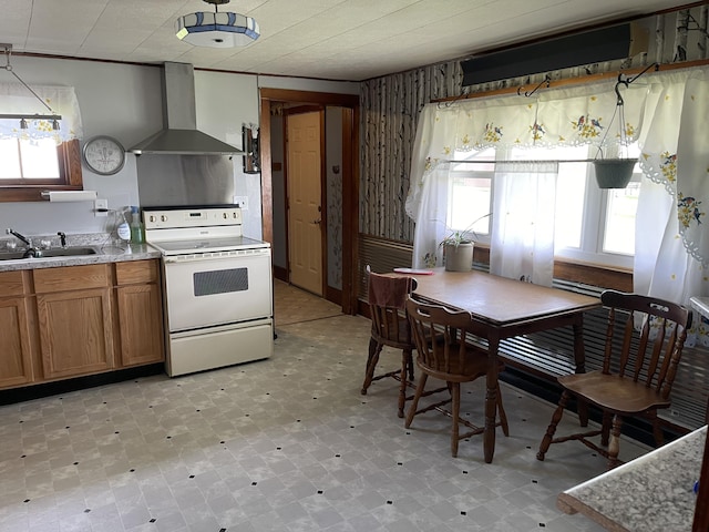 kitchen featuring wall chimney range hood, brown cabinets, a sink, white range with electric stovetop, and light countertops