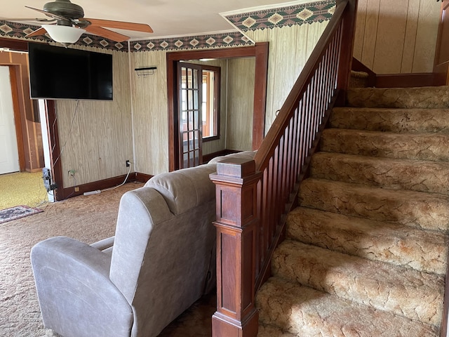 stairs with a ceiling fan, carpet flooring, and baseboards
