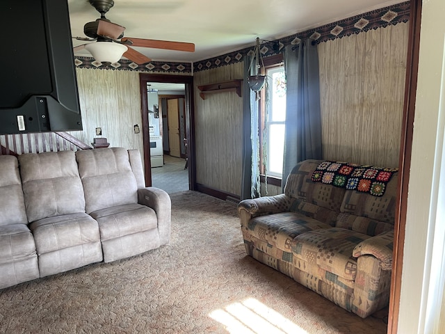 carpeted living room with a ceiling fan