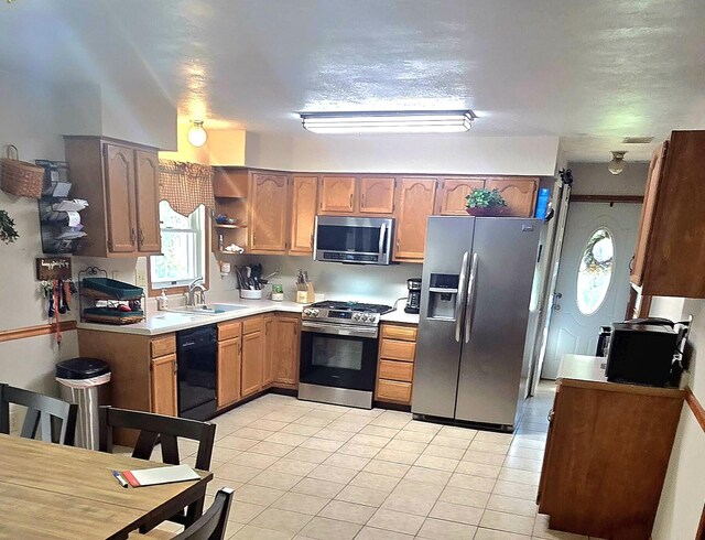 10141 Mohawk Dr, Huntsville, OH 43324 - kitchen with appliances with stainless steel finishes, light tile patterned floors, light countertops, and open shelves