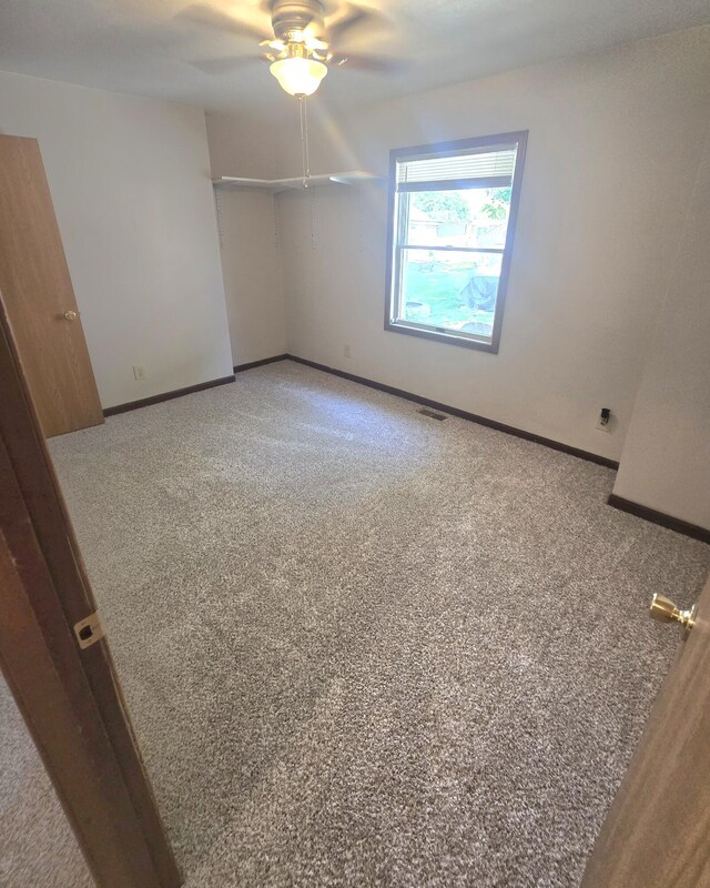10141 Mohawk Dr, Huntsville, OH 43324 - carpeted spare room with ceiling fan and baseboards