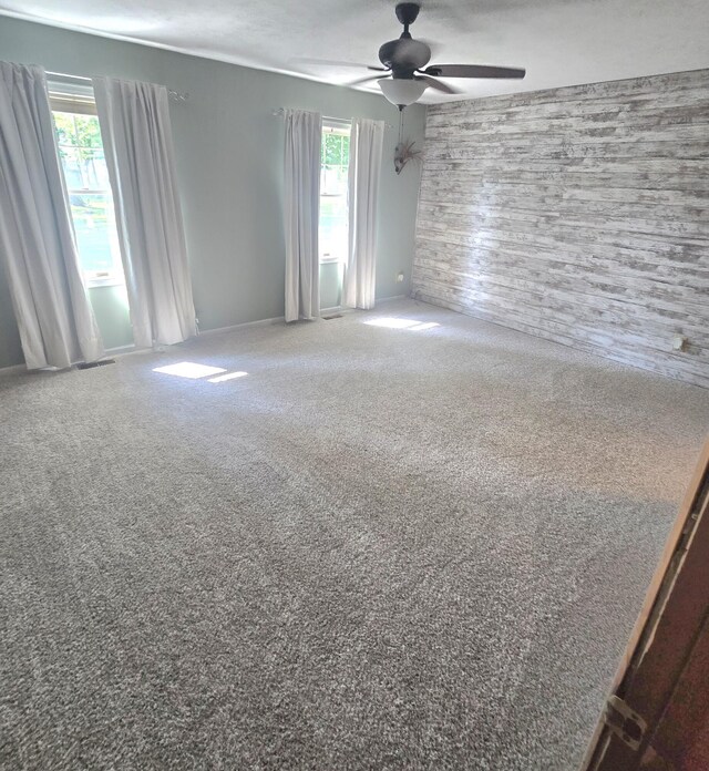 10141 Mohawk Dr, Huntsville, OH 43324 - carpeted empty room with a ceiling fan