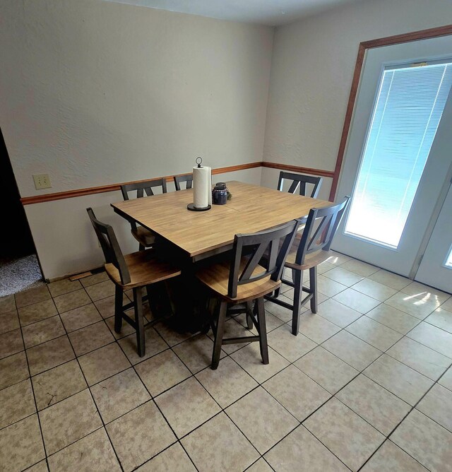 10141 Mohawk Dr, Huntsville, OH 43324 - dining space featuring light tile patterned floors