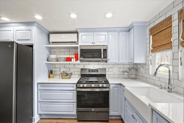 kitchen with stainless steel appliances, a sink, a wall mounted AC, decorative backsplash, and open shelves