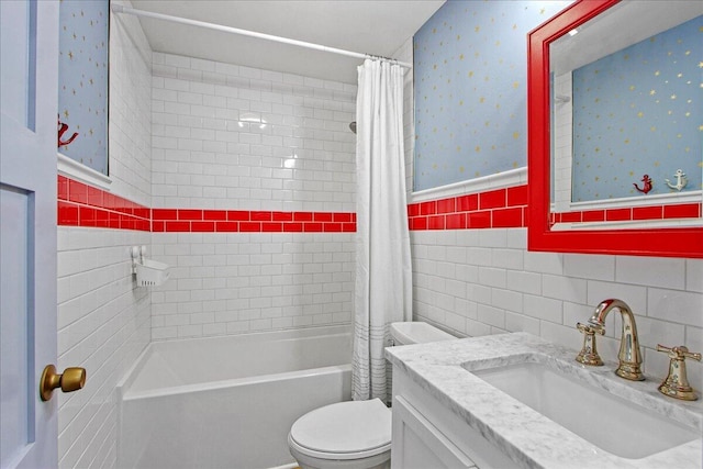 bathroom with wallpapered walls, shower / bath combo, toilet, vanity, and tile walls