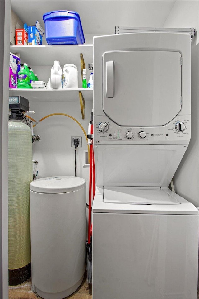 clothes washing area with laundry area and stacked washer / dryer