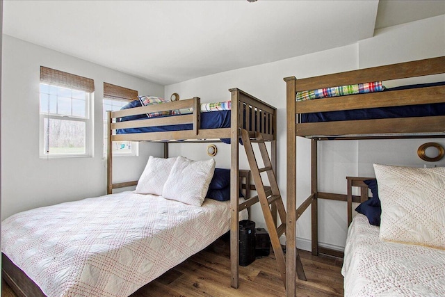 bedroom featuring dark wood-style floors and baseboards