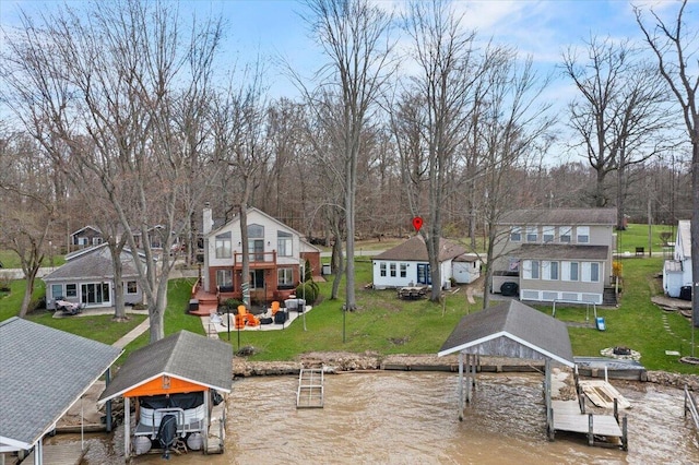 dock area with a water view, boat lift, and a residential view