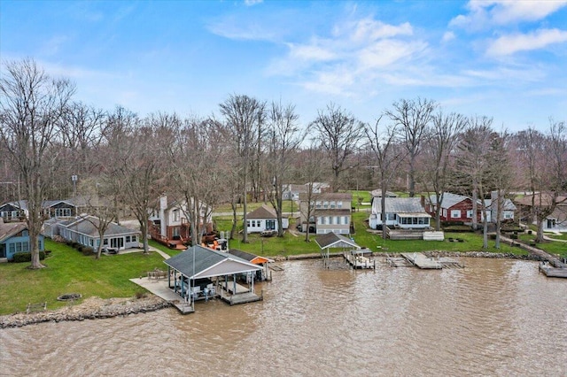 birds eye view of property featuring a water view and a residential view