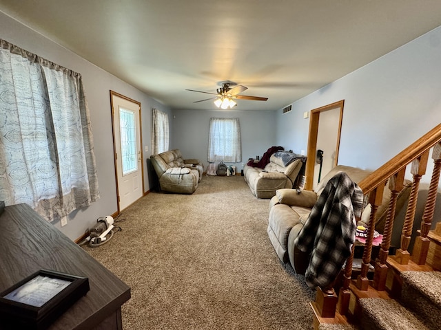 641 Washington St, Versailles, OH 45380 - living room featuring carpet, stairs, and a ceiling fan