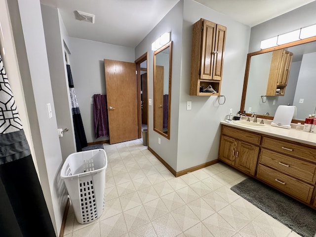 641 Washington St, Versailles, OH 45380 - bathroom with a freestanding tub, vanity, baseboards, and tile patterned floors