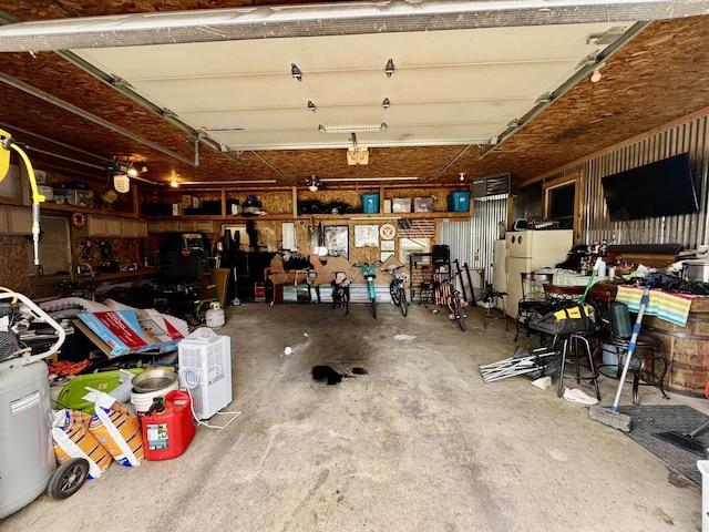 641 Washington St, Versailles, OH 45380 - garage with freestanding refrigerator and a workshop area