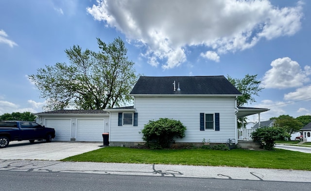 641 Washington St, Versailles, OH 45380 - view of property exterior featuring a lawn, a garage, and concrete driveway