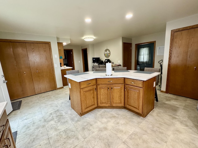 641 Washington St, Versailles, OH 45380 - kitchen with light countertops, brown cabinets, and a kitchen island with sink