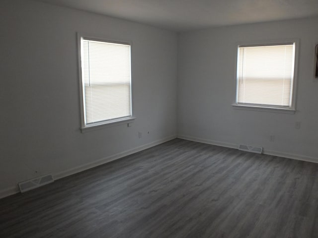 324 E Maplewood Ave, Dayton, OH 45405 - spare room with baseboards, visible vents, and dark wood-style flooring