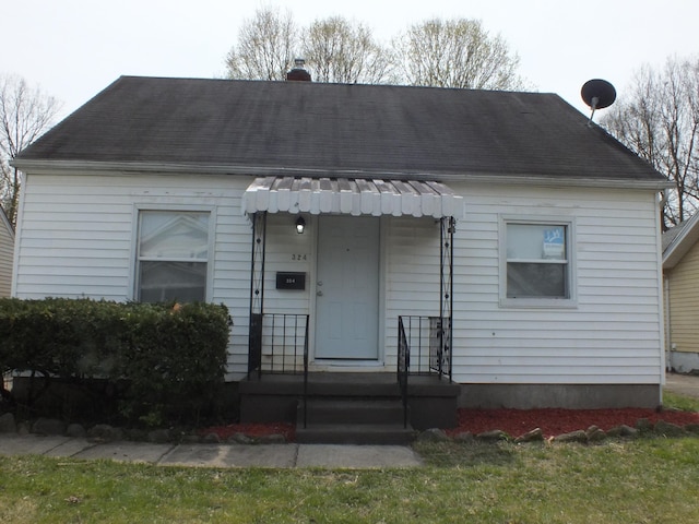 324 E Maplewood Ave, Dayton, OH 45405 - view of front of home featuring a shingled roof and a chimney