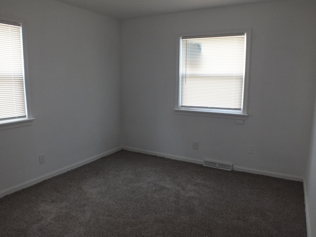 324 E Maplewood Ave, Dayton, OH 45405 - spare room featuring baseboards, carpet flooring, visible vents, and plenty of natural light