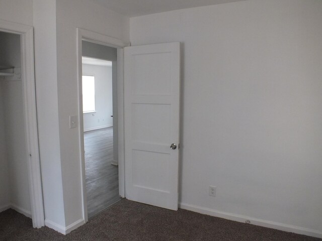 324 E Maplewood Ave, Dayton, OH 45405 - unfurnished bedroom with baseboards and dark colored carpet