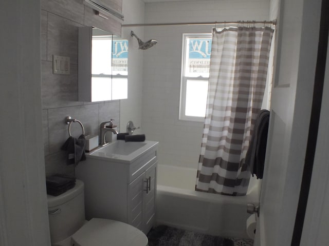 324 E Maplewood Ave, Dayton, OH 45405 - full bathroom with tile walls, toilet, vanity, and shower / bathtub combination with curtain