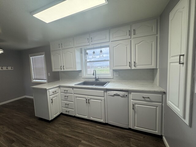 kitchen featuring a sink, white cabinetry, dishwasher, and dark wood-type flooring