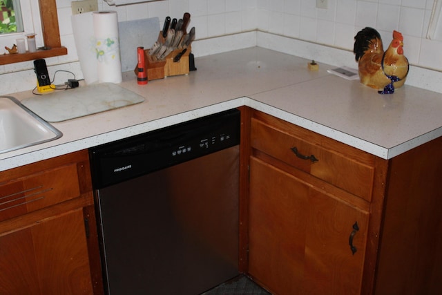 6 Woodside Dr, Arcanum, OH 45304 - kitchen with stainless steel dishwasher, backsplash, brown cabinets, and light countertops