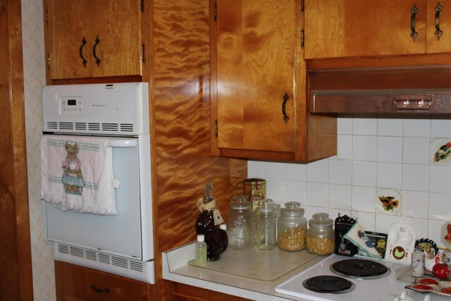 6 Woodside Dr, Arcanum, OH 45304 - kitchen featuring white oven, extractor fan, decorative backsplash, and light countertops
