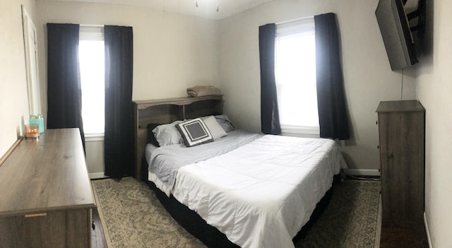 bedroom featuring multiple windows and baseboards