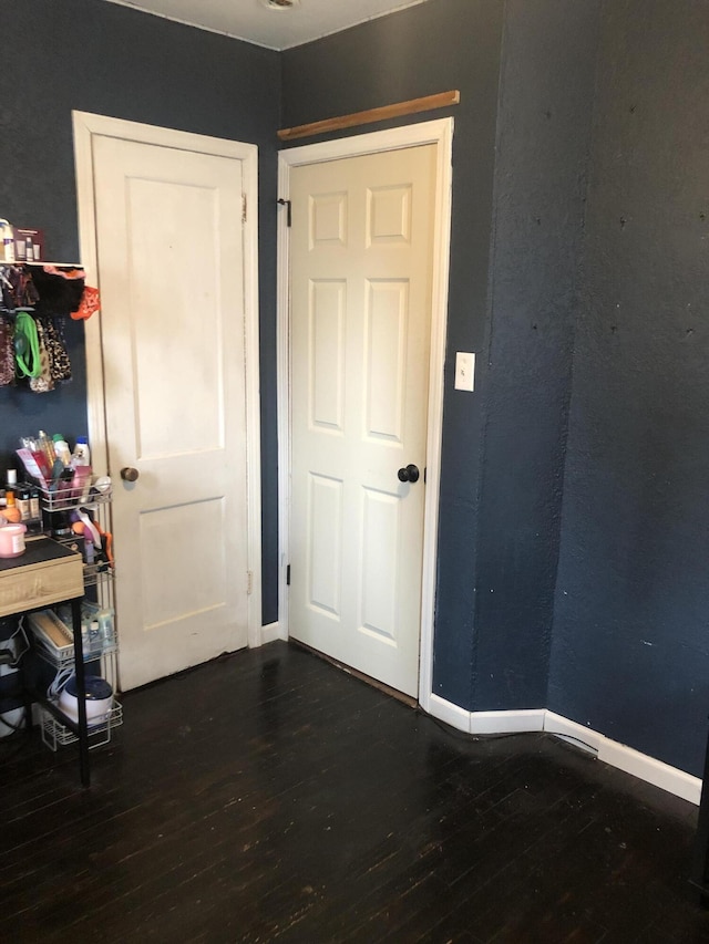 interior space featuring dark wood finished floors and baseboards