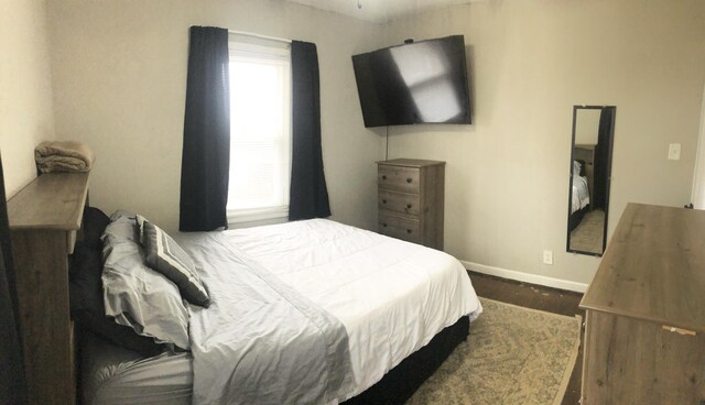 bedroom with wood finished floors and baseboards