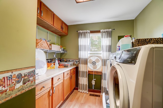 3727 Groves Rd, Lima, OH 45805 - laundry area with independent washer and dryer, light wood-style floors, and cabinet space