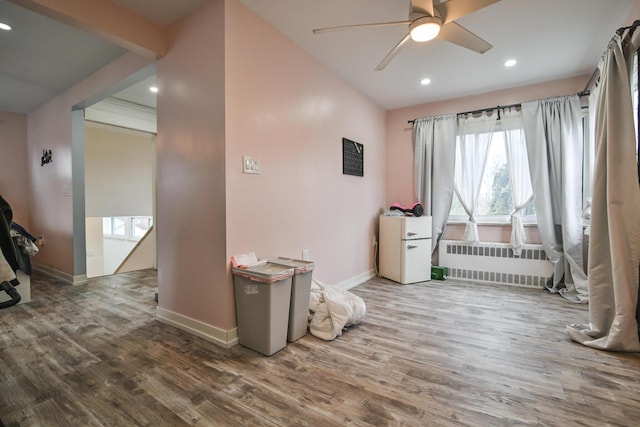 interior space featuring hardwood / wood-style flooring, radiator heating unit, and ceiling fan