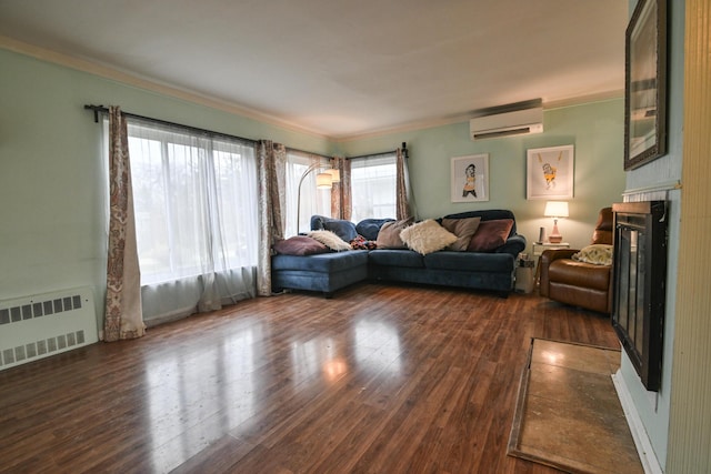 living room featuring dark wood-type flooring, radiator heating unit, ornamental molding, and an AC wall unit