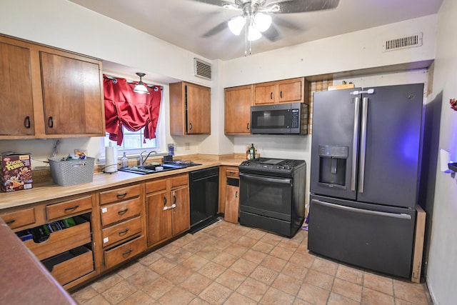 kitchen featuring ceiling fan, sink, and black appliances