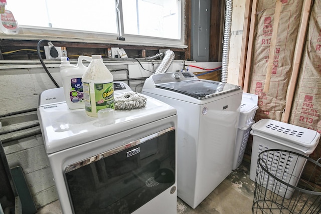 washroom with cabinets and washing machine and clothes dryer