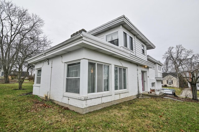 view of side of home featuring a yard