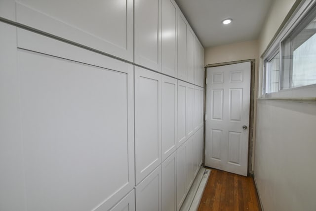 hallway with dark hardwood / wood-style flooring