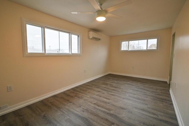 spare room with dark hardwood / wood-style flooring, ceiling fan, a wealth of natural light, and a wall mounted AC