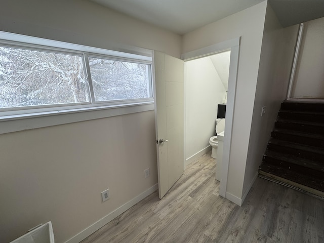 bathroom featuring hardwood / wood-style floors and toilet